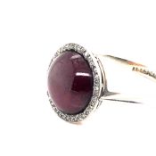 AN ANTIQUE CABOCHON GARNET AND ROSE CUT DIAMOND RING. THE INSIDE SHANK STAMPED 18ct WG, ASSESSED