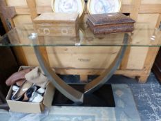 A GLASS TOPPED CONSOLE TABLE.