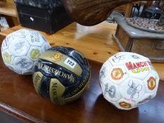 THREE MANCHESTER UNITED FOOTBALLS.