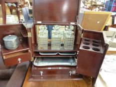 AN ART DECO PERIOD MAHOGANY TANTALUS/ SMOKERS COMPENDIUM