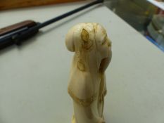 AN ANTIQUE CARVED IVORY FIGURE OF AN IMMORTAL WITH SIGNATURE TABLET TRANSLATING JUROJIN.