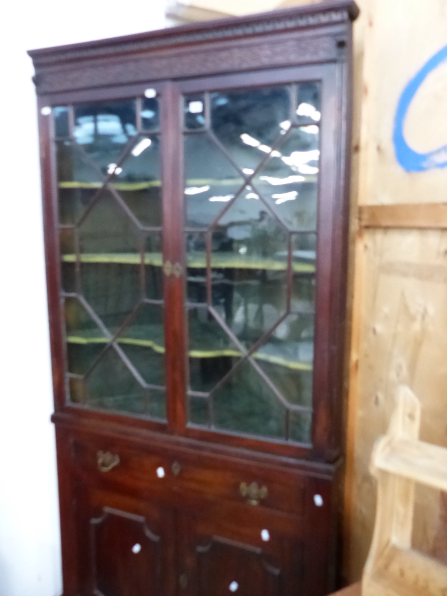 A GEORGE III MAHOGANY GLAZED CORNER CABINET.