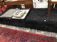 A PAIR OF OTTOMANS UPHOLSTERED IN BLACK VELVET CUT TO SIMULATE CROCODILE SKIN.