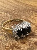 A 9ct GOLD AND CZ MULTI CLUSTER RING IN A CLAW SETTING. FINGER SIZE N, WEIGHT 2.82grms.