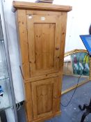 A PINE TWO DOOR CABINET.