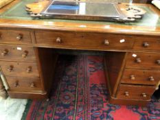 A 20th C. MAHOGANY PEDESTAL DESK WITH GREEN LEATHER INSET TOP OVER A KNEEHOLE DRAWER FLANKED BY