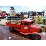 A TRI-ANG TIN PLATE CLOCK WORK DELIVERY TRUCK COMPLETE WITH SIX CHURNS.