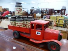 A TRI-ANG TIN PLATE CLOCK WORK DELIVERY TRUCK COMPLETE WITH SIX CHURNS.