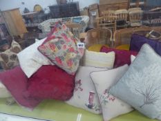 A COLLECTION OF SOFT FURNISHING SCATTER CUSHIONS AND A FOLDING LUGGAGE STAND.