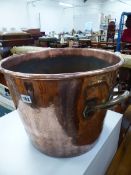 AN ANTIQUE COPPER TWO HANDLED BUCKET.