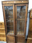 A 20th C. OAK DISPLAY CABINET WITH LEADED GLASS DOORS WITHIN BATON AND BEAD BANDS. W 87 x D 30 x H