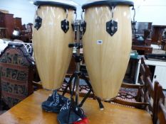 A PAIR OF TOCA HAND PERCUSSION BONGOS ON STAND WITH A DVD INSTRUCTION MANUAL.