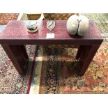A RED SNAKESKIN PIER TABLE. W 100 x D 35 x H 75cms.
