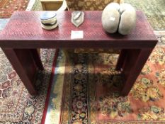A RED SNAKESKIN PIER TABLE. W 100 x D 35 x H 75cms.