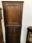 A GEORGE III OAK BOW FRONT CORNER CUPBOARD TOGETHER WITH ANOTHER FLAT FRONTED