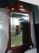 AN ANTIQUE FRET FRAMED WALL MIRROR AND ONE OTHER SIMILAR MIRROR.