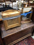 A CANE FRAMED DRESSING TABLE MIRROR TOGETHER WITH A PINE WALL CUPBOARD WITH PULL DOWN DOOR