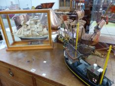 A MODEL SHIP, CUTTY SARK IN GLAZED CASE AND TWO OTHER BOAT MODELS.