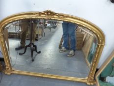 A VICTORIAN STYLE GILT FRAMED OVER MANTLE MIRROR.