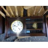 AN OAK CASED STRIKING WALL CLOCK.