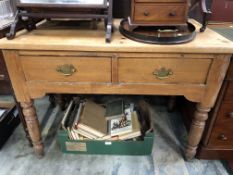 A PINE TABLE WITH TWO DRAWERS ABOVE THE TURNED CYLINDRICAL LEGS ON SPINDLE FEET. W 107 x D 64.5 x