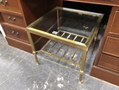 A GLASS TOPPED BRASS COFFEE TABLE WITH BAR UNDER TIER.