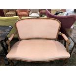 A 20th C. STAINED WOOD SHOW FRAME TWO SEAT SETTEE UPHOLSTERED IN PINK VELVET. W 116cms