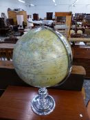 A LARGE GLOBE ON SILVERED STAND.