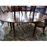 A LARGE OAK WAKE TABLE ON TURNED LEGS WITH CLUB FEET.