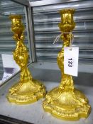 A PAIR OF 19th C. GILT BRONZE CANDLESTICKS WITH THE NOZZLES SUPPORTED BY THREE NAKED FIGURES WITH