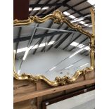 A DECORATIVE GILT FRAMED MIRROR, H 79cms W 100cms