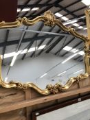 A DECORATIVE GILT FRAMED MIRROR, H 79cms W 100cms