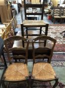 A PAIR OF FRENCH OAK RUSH SEATED CHAIRS TOGETHER WITH ANOTHER RUSH SEATED CHAIR WITH PAINTED BAR