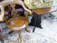 AN ANTIQUE MAHOGANY SWIVEL OFFICE CHAIR AND AN OAK OCCASIONAL TABLE.