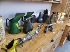 A COLLECTION OF VINTAGE AUTOMOBILIA OIL CANS, A FUEL PUMP HEAD, GREASE GUNS, TWO ESSO CAST IRON LOGO