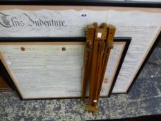 TWO FRAMED INDENTURE. TOGETHER WITH A SMALL ARTIST EASEL
