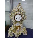 A BREGUET MARKED DIAL TO A CLOCK STRIKING ON A BELL IN A FLOWER ENCRUSTED PORCELAIN CASE