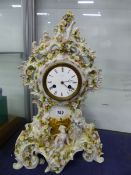 A BREGUET MARKED DIAL TO A CLOCK STRIKING ON A BELL IN A FLOWER ENCRUSTED PORCELAIN CASE