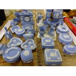 A COLLECTION OF WEDGWOOD BLUE JASPER WARES, TO INCLUDE COVERED BOXES, SWEET DISHES AND A CLOCK