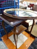 A MAHOGANY OCCASIONAL TABLE AND AN OVAL MIRROR.