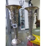 A PAIR OF HALLMARKED SILVER BUD VASES WITH GEOMETRIC PIERCED DECORATION EACH WITH A GLASS LINER.