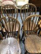 A SET OF FOUR OAK HOOP BACKED KITCHEN CHAIRS BY HAINES OF WYCOMBE.