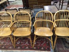 A SET OF FOUR MODERN ASH WINDSOR CHAIRS WITH SADDLE SEATS OVER CRINOLINE STRETCHERS