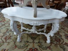 A ROCOCO STYE PAINTED CENTRE TABLE WITH CARVED DECORATION WITH TWO DRAWERS.