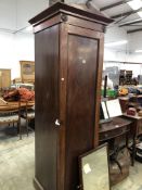 A 19th C. MAHOGANY WARDROBE, THE TRIANGULAR PEDIMENT CENTRED BY A FLOWER, THE DOOR OPENING ONTO