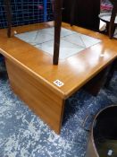 A TEAK AND TILE TOP TABLE.