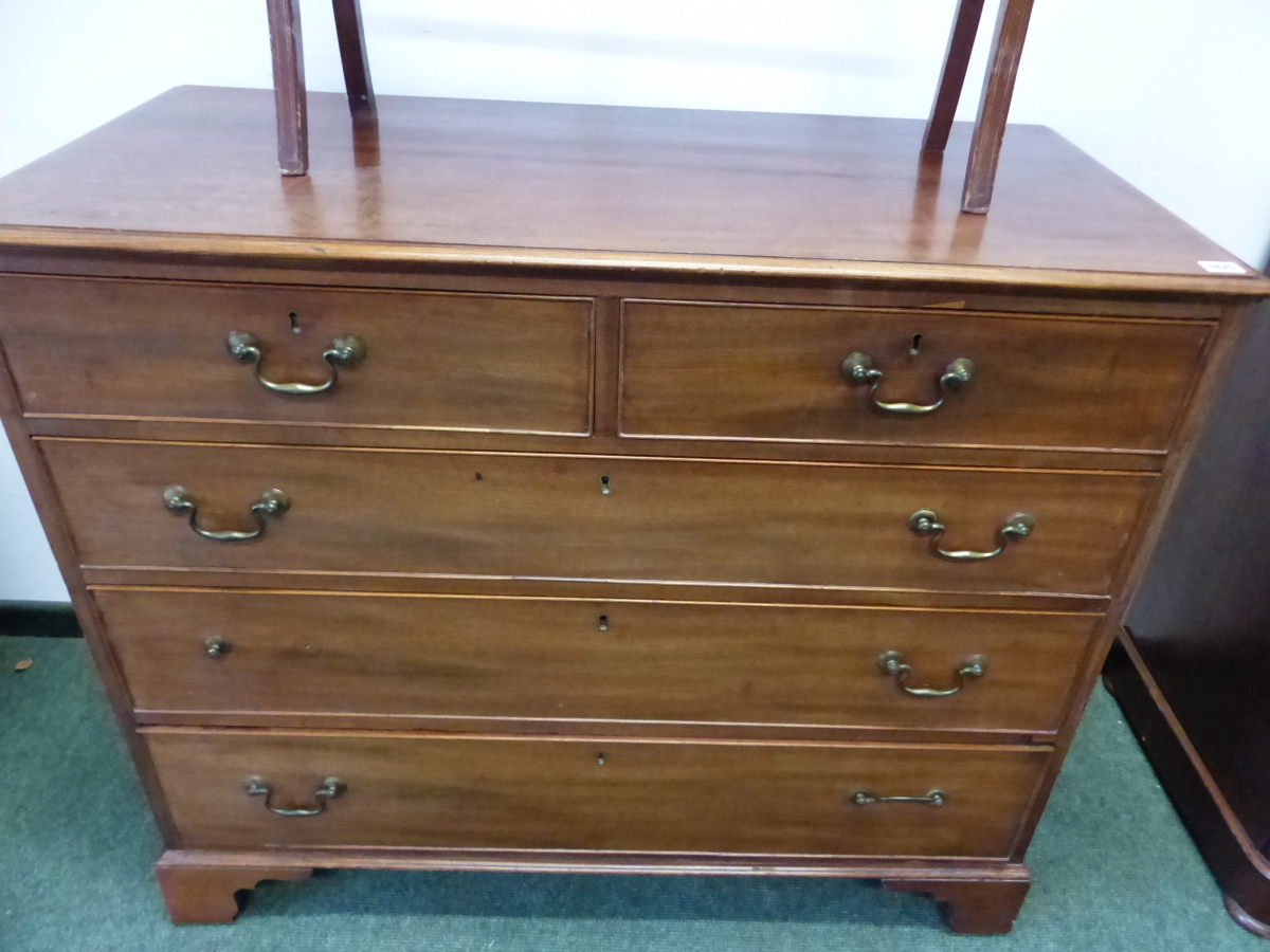 A 19th C. MAHOGANY CHEST OF TWO SHORT AND THREE LONG DRAWERS ON BRACKWT FEET.
