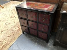 AN ORIENTAL PAINTED BLACK LACQUER SPICE CABINET OF THREE BANKS OF THREE DRAWERS. W 66 x D 35.5 x H