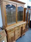 AN ANTIQUE PINE DRESSER WITH GLAZED BOOK CASE OVER.