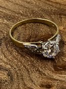 A 9ct HALLMARKED GOLD CZ SOLITAIRE WITH STONE SET SHOULDERS. FINGER SIZE O. WEIGHT 2.85grms.